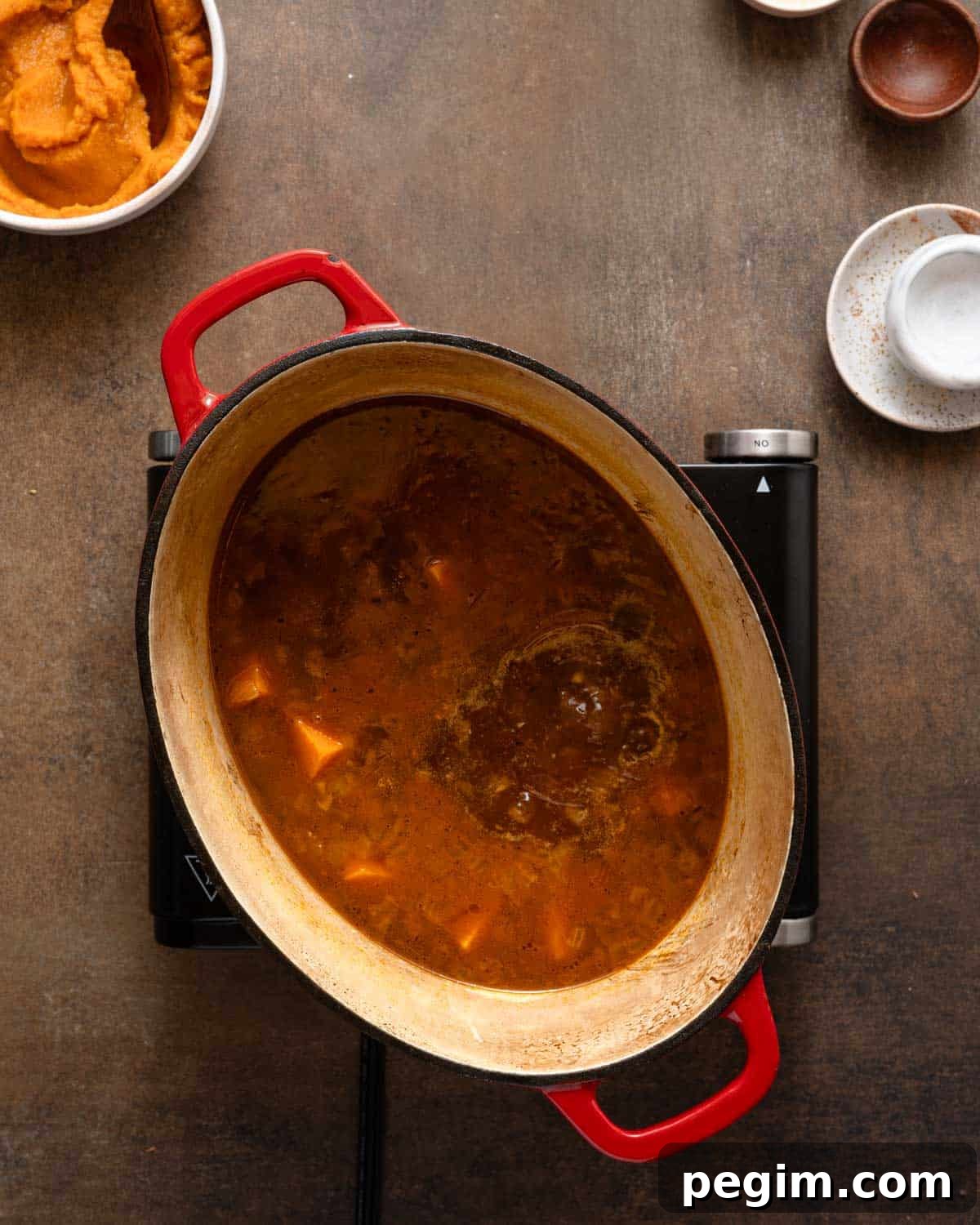 sweet potato soup gently boiling on burner.