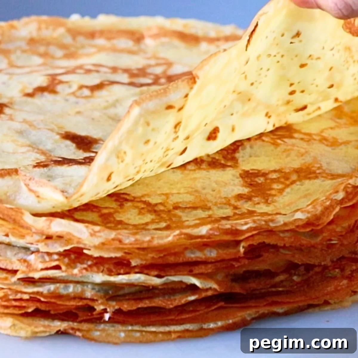 a thin crepe, piled up on a table