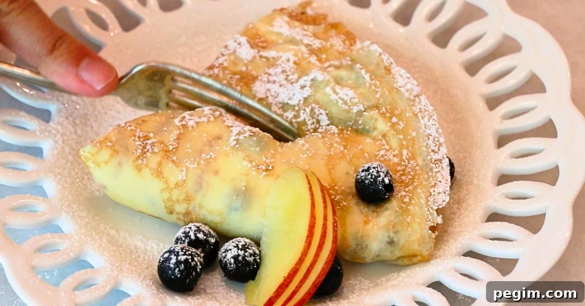 a homemade crepe filled with yogurt and decorated with fruits