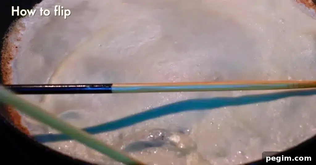 showing how to flip a crepe using chopsticks