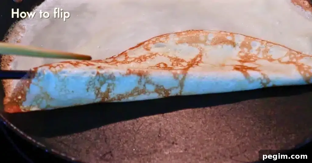 flipping over the crepe edge using a chopstick