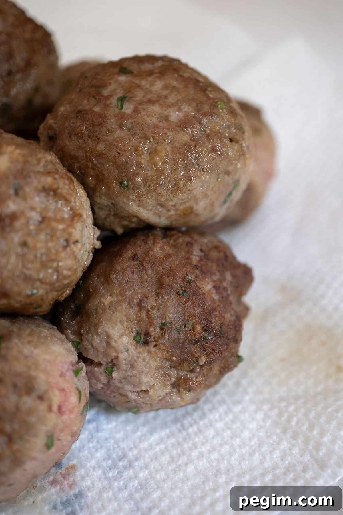 Pile of fried meatballs showing crispy texture. 