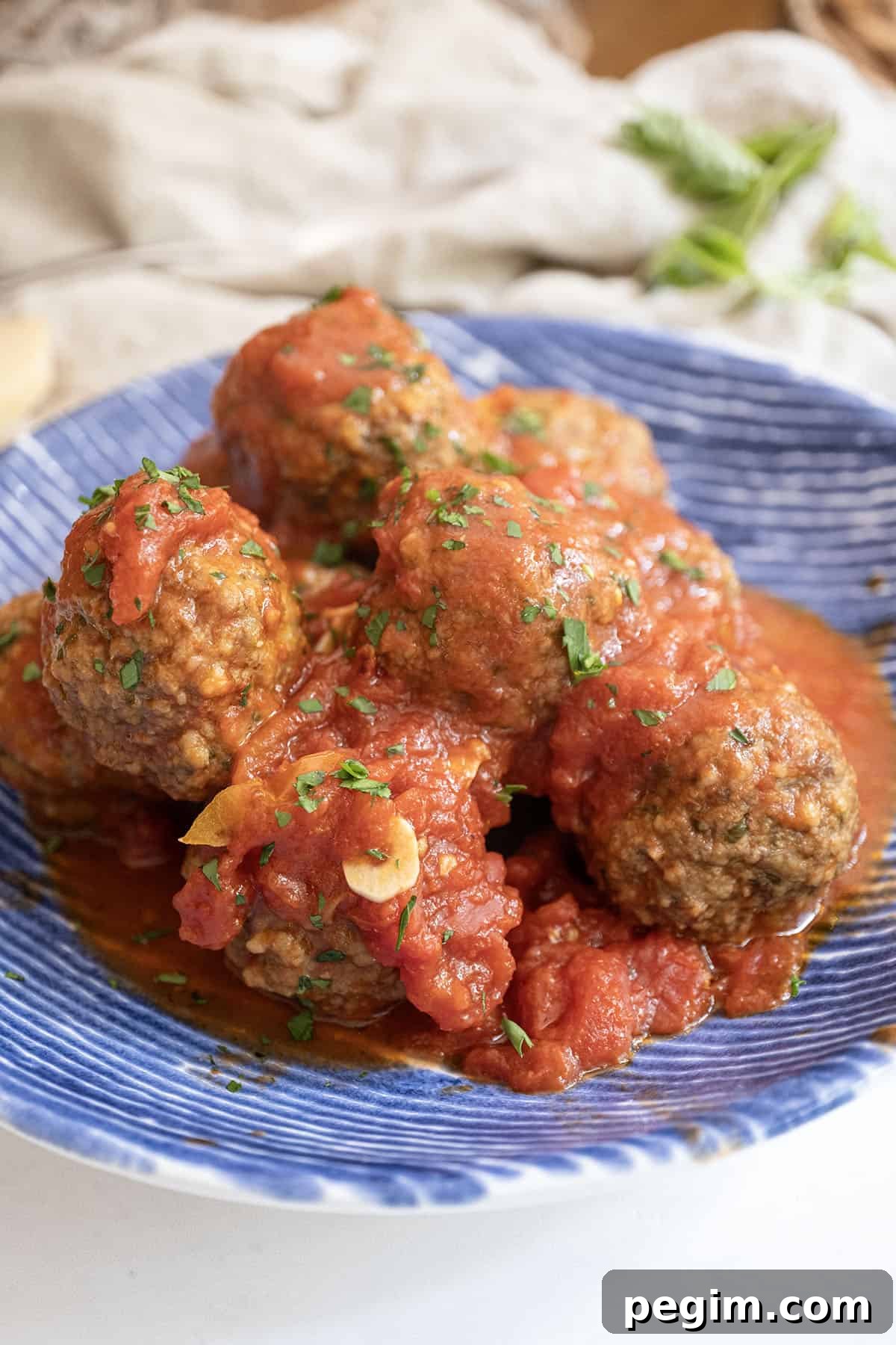 Meatballs covered in tomato sauce in a bowl.