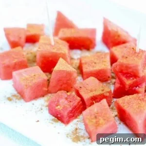 Chunks of fresh watermelon topped with Tajin and cinnamon.