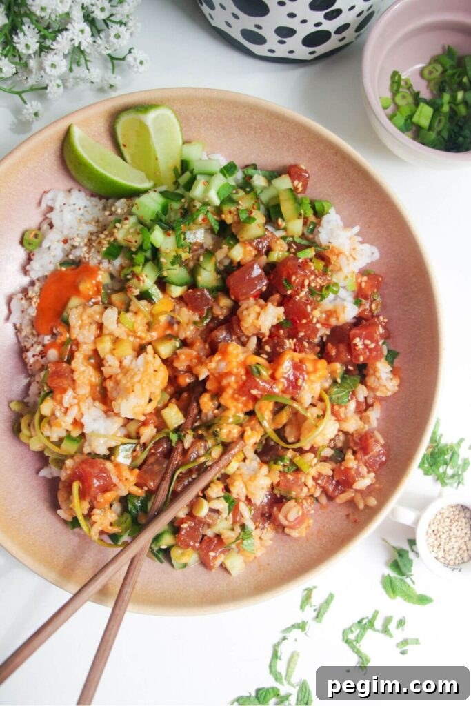 Tuna poke bowl with chopsticks on the side.