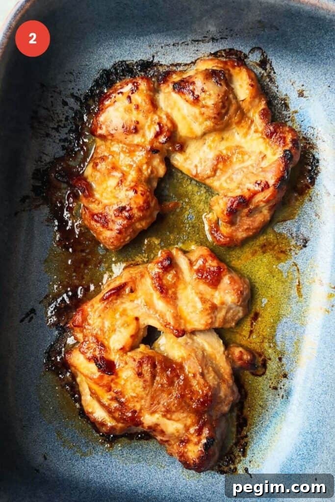 Cooked miso chicken thighs in an oven dish.