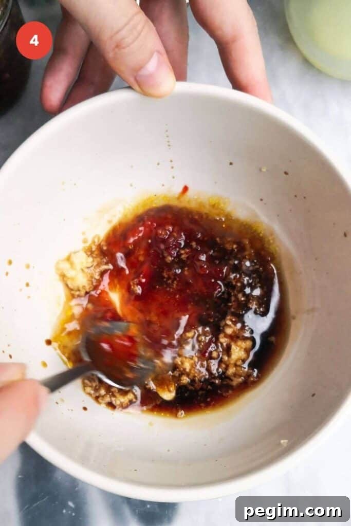 Mixing miso dressing in a bowl.