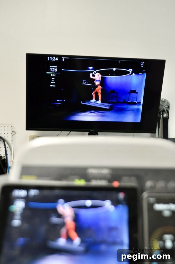 a television airplaying a peloton tread workout.