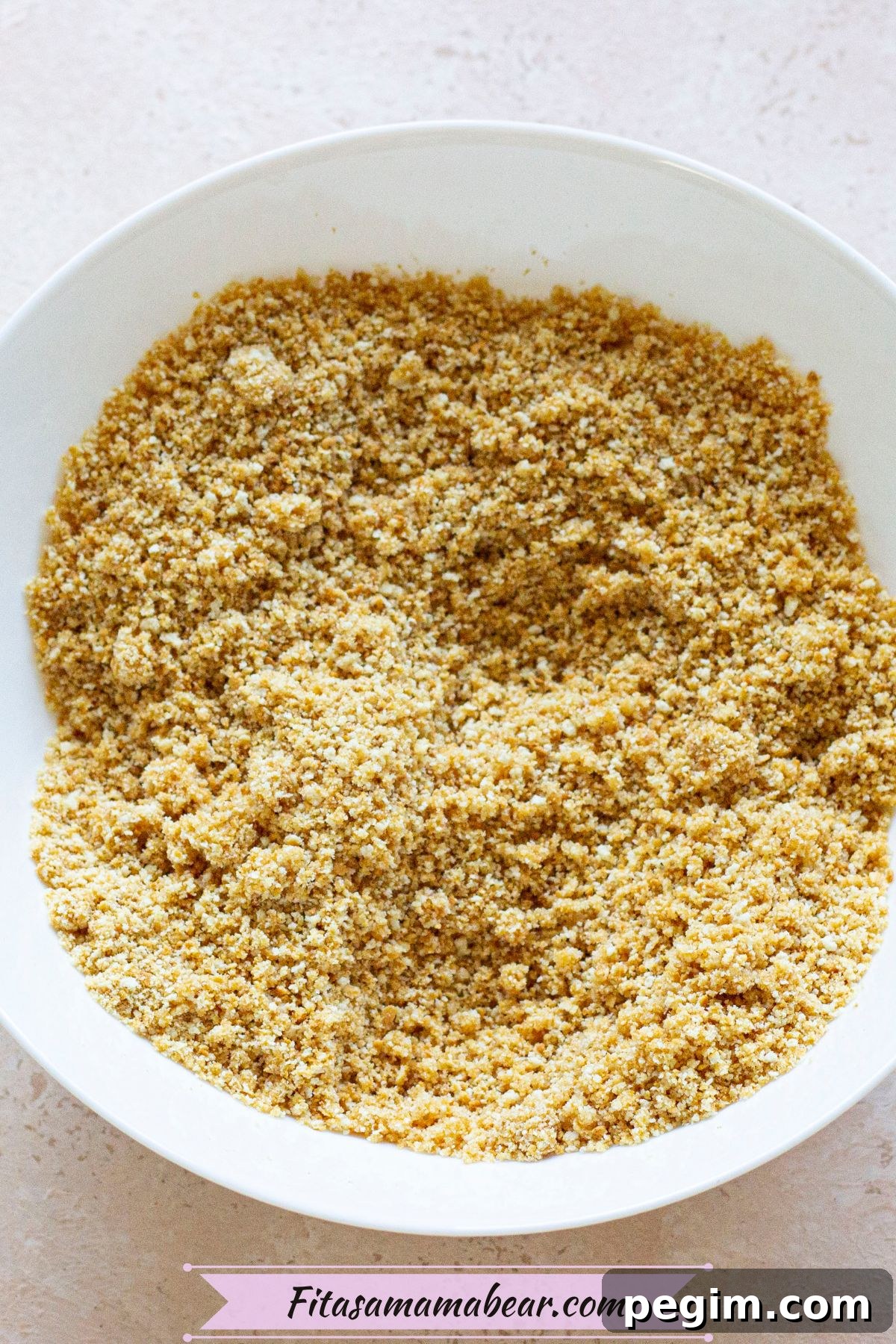 Crumbled graham crackers in a white bowl.
