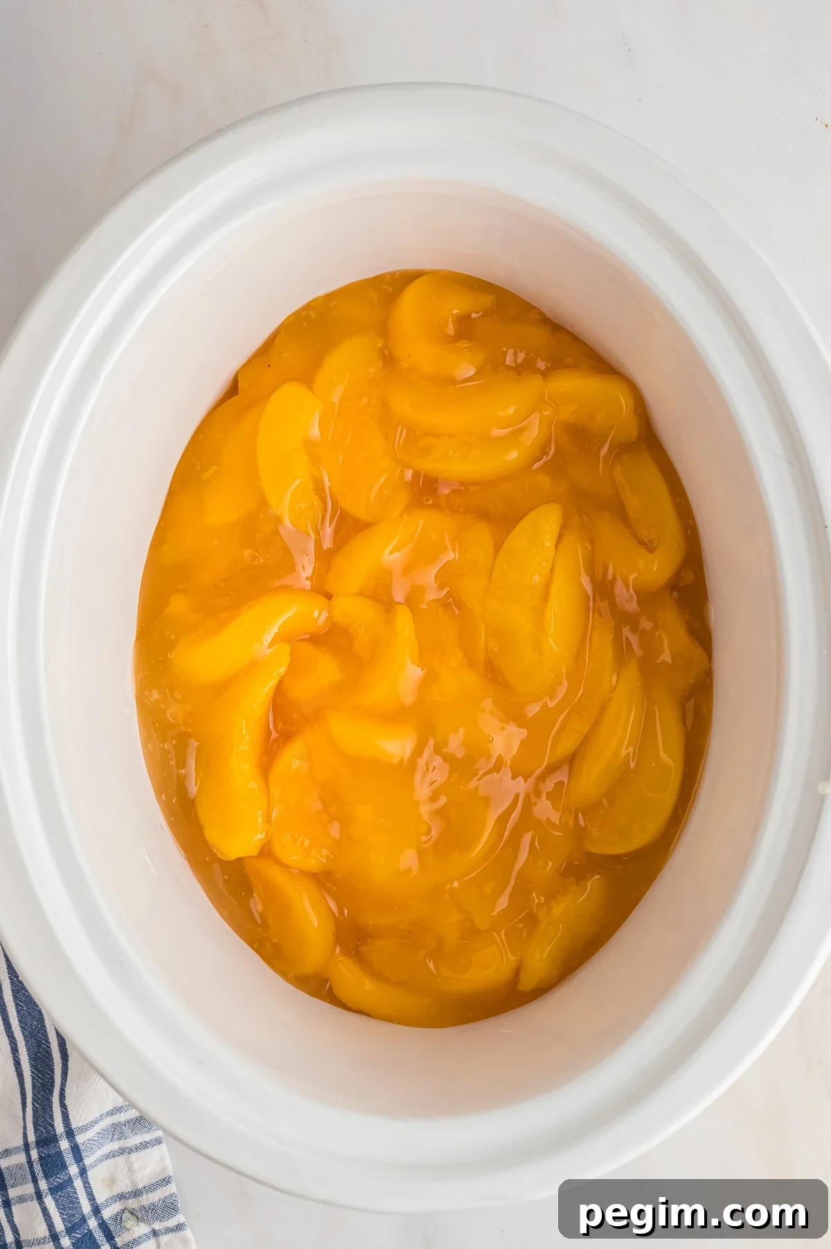 CANNED PEACHES ON THE BOTTOM OF A SLOW COOKER.