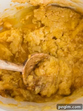 crockpot with peach cobbler with some dished out.