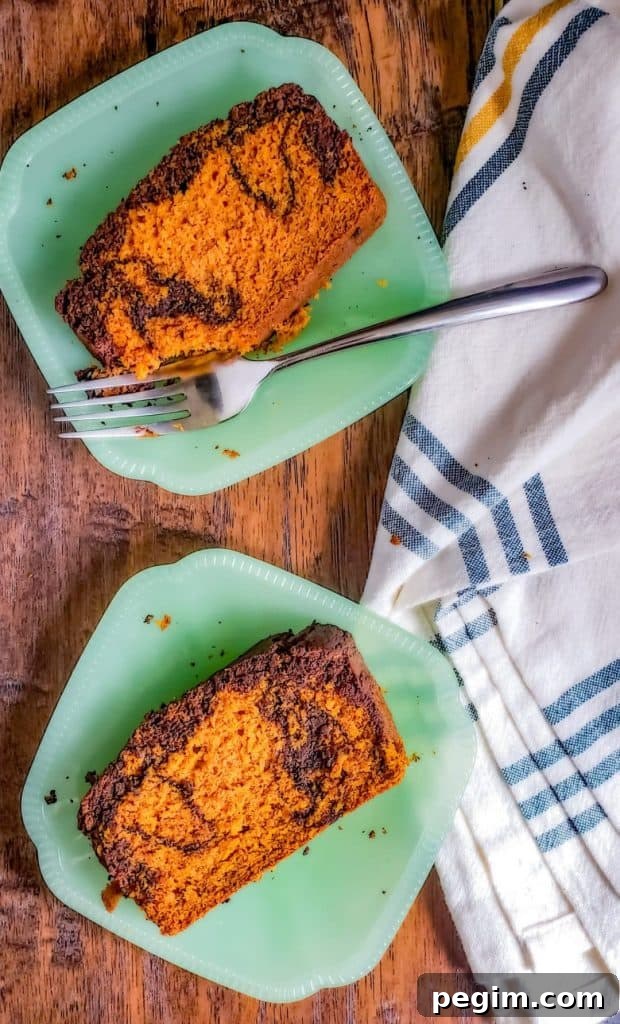 Overhead shot of two green plates with pumpkin bread on them.