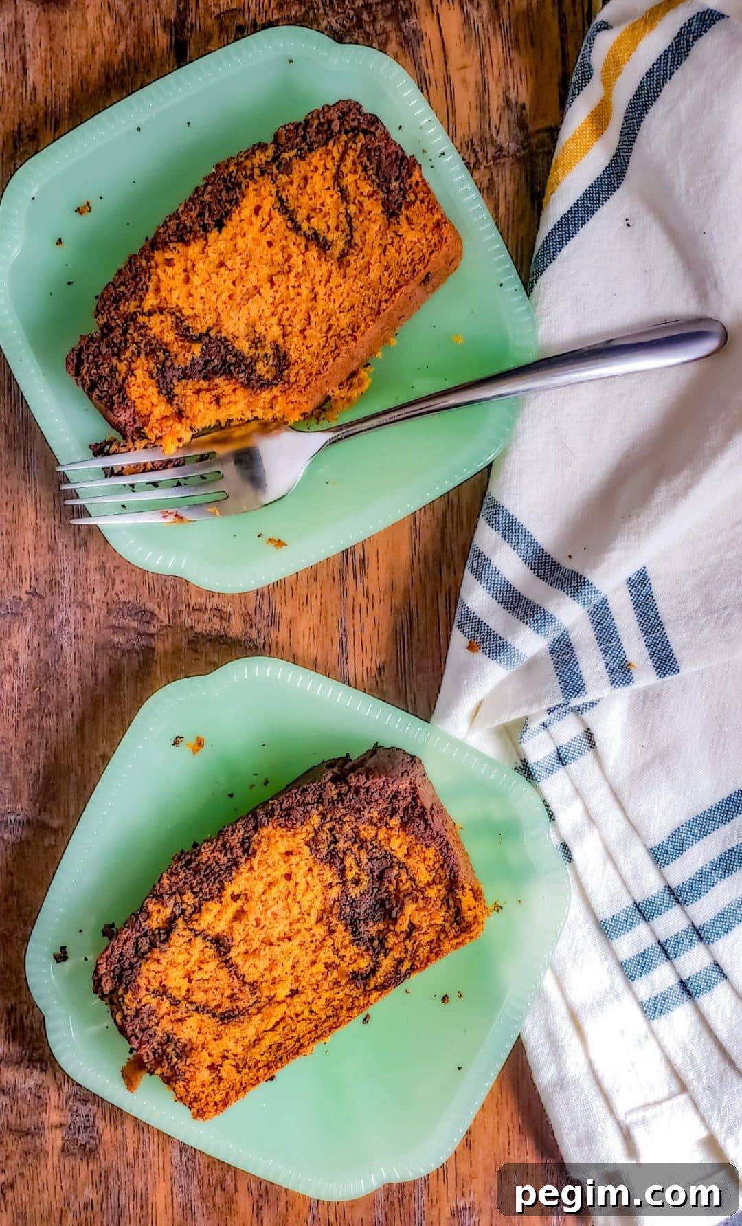 Overhead shot of two green plates with pumpkin bread on them.