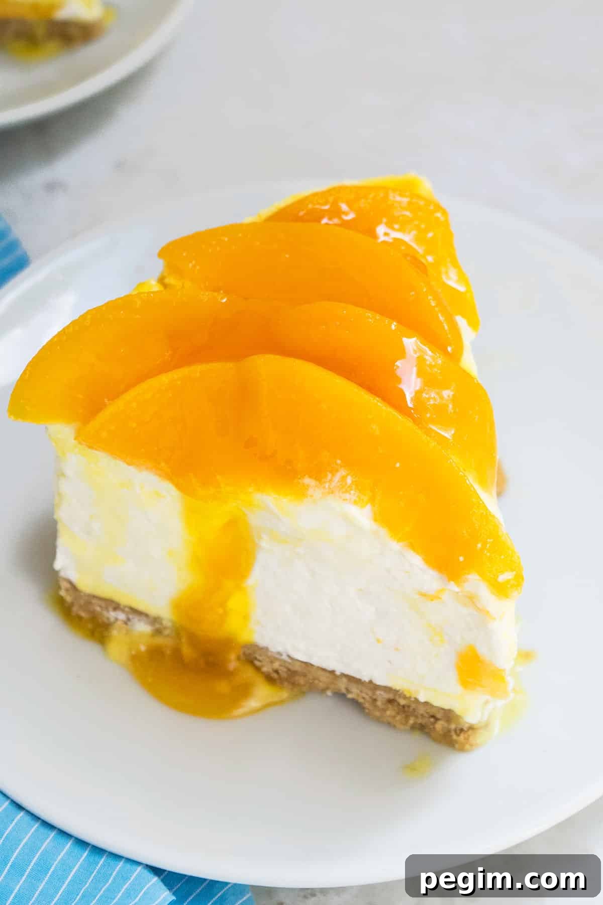 Slice of cheesecake on white dish.