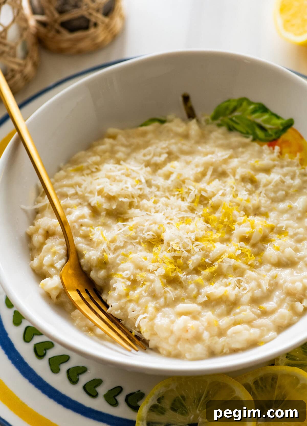 A bowl of lemon risotto with a fork resting in it.