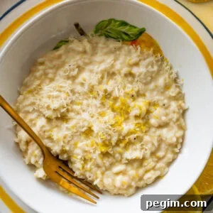 A bowl of lemon risotto with a fork resting in it.