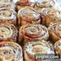 Hot Ham & Cheesy Party Rolls side by side in a pan