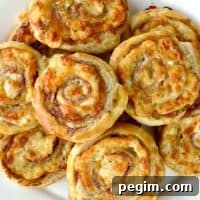 Cheesy French Pinwheels piled up on a plate