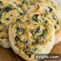 close up of Spinach Dip Pinwheels on a cutting board