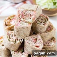 Ranch BLT Roll Ups stacked up on a plate