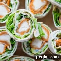 Buffalo Chicken Roll Up Appetizers on a cutting board