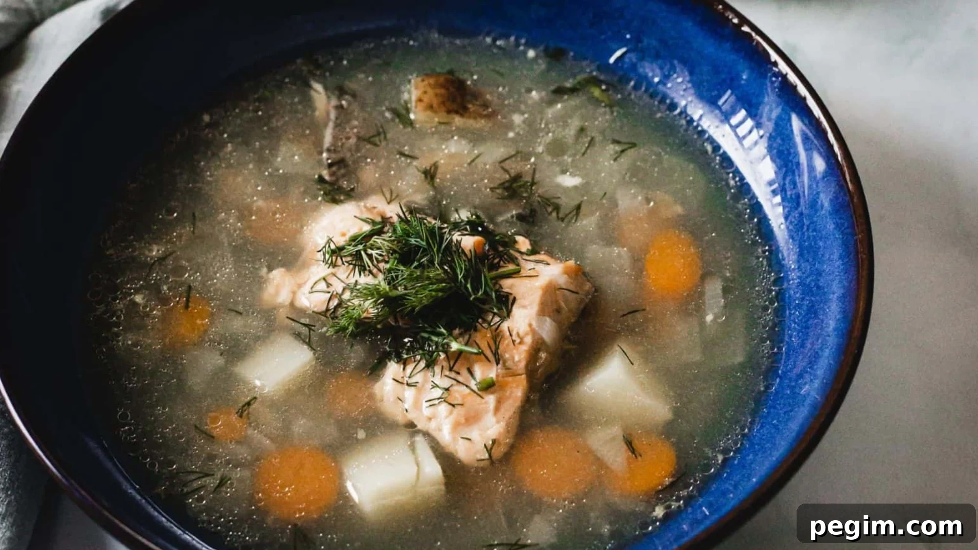 Overhead view of blue bowl of soup.