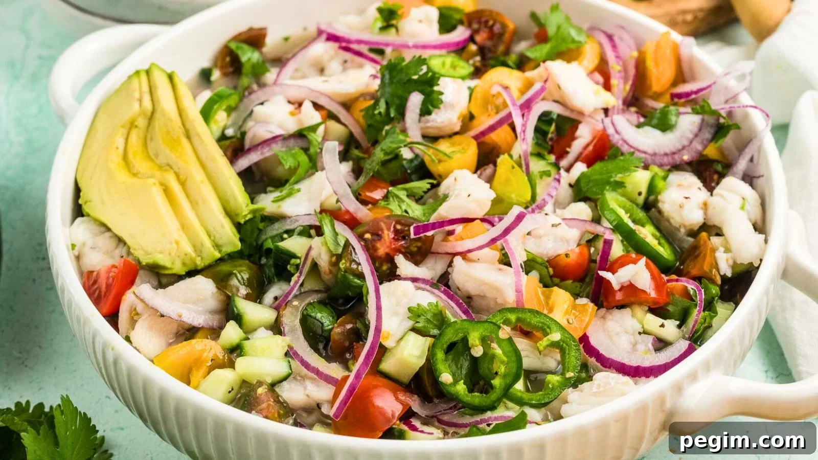 Fresh fish ceviche with bright citrus, peppers, and herbs served chilled in a bowl.