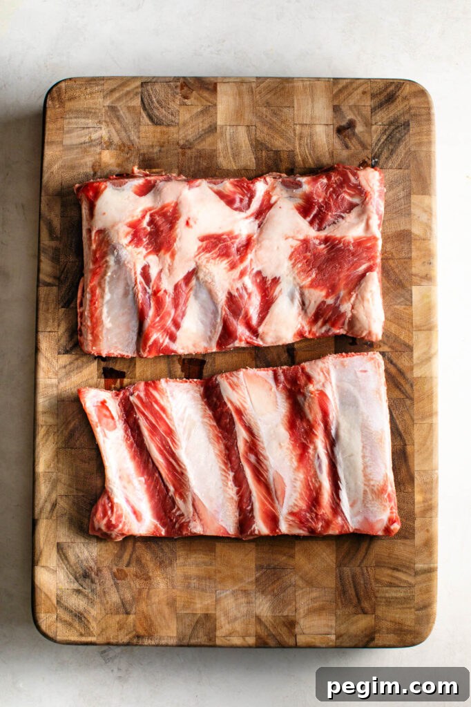 raw beef back ribs on a cutting board