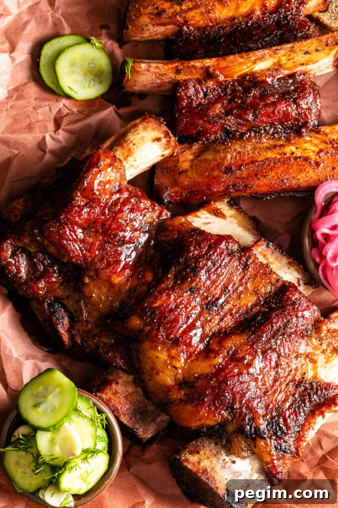 easy smoked beef back with pickles and pickled red onions on peach butcher paper