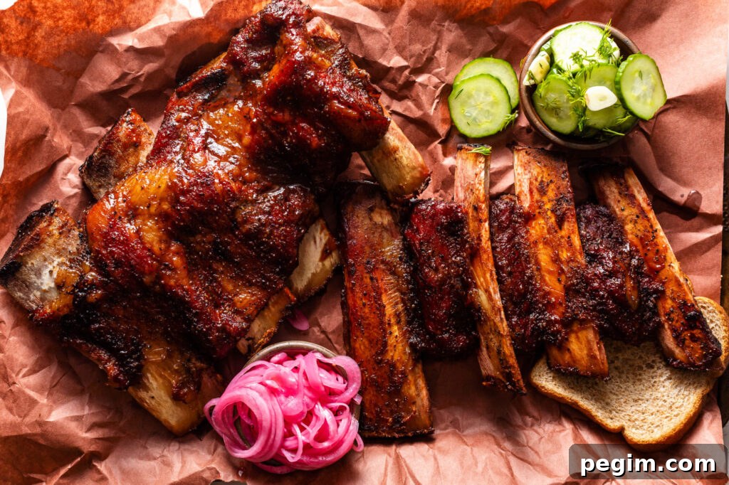 easy smoked beef back ribs on peach butcher paper with bread, pickles and pickled red onions