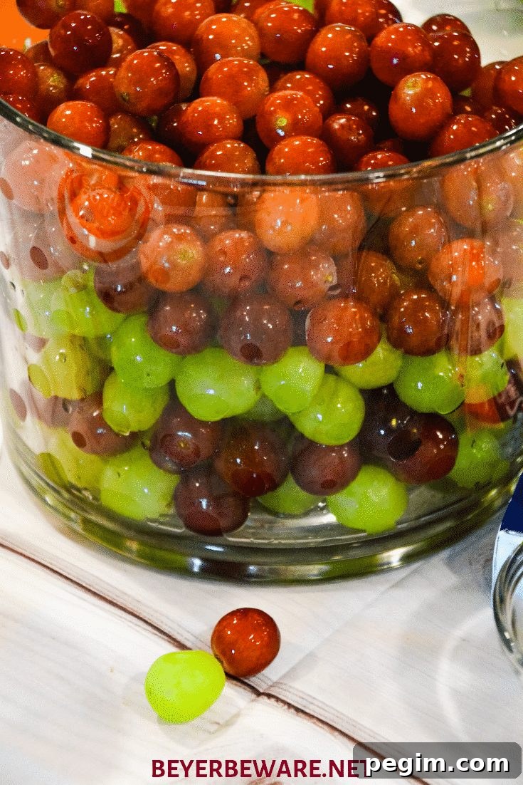 Mixing creamy dressing with red and green grapes.