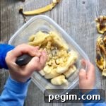 kids mashing bananas in a plastic container