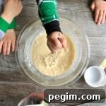 little kids whisking pancake mix in a bowl