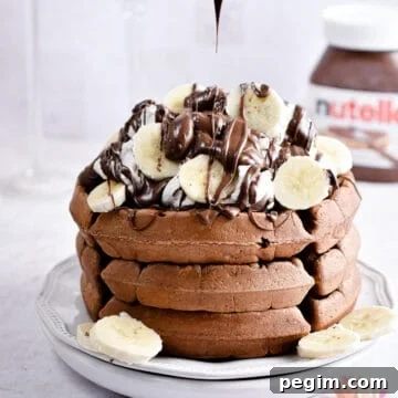 Nutella is being drizzled on the Nutella waffles.