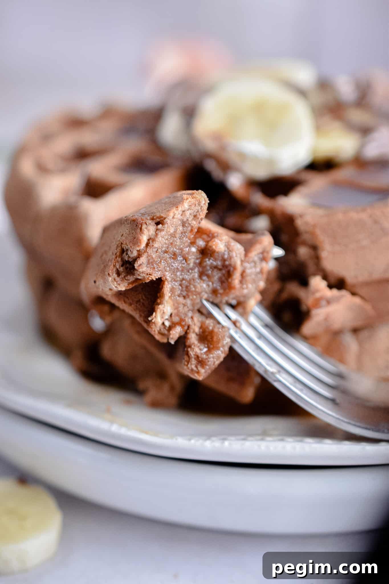 A piece of the Nutella waffle is on the fork.