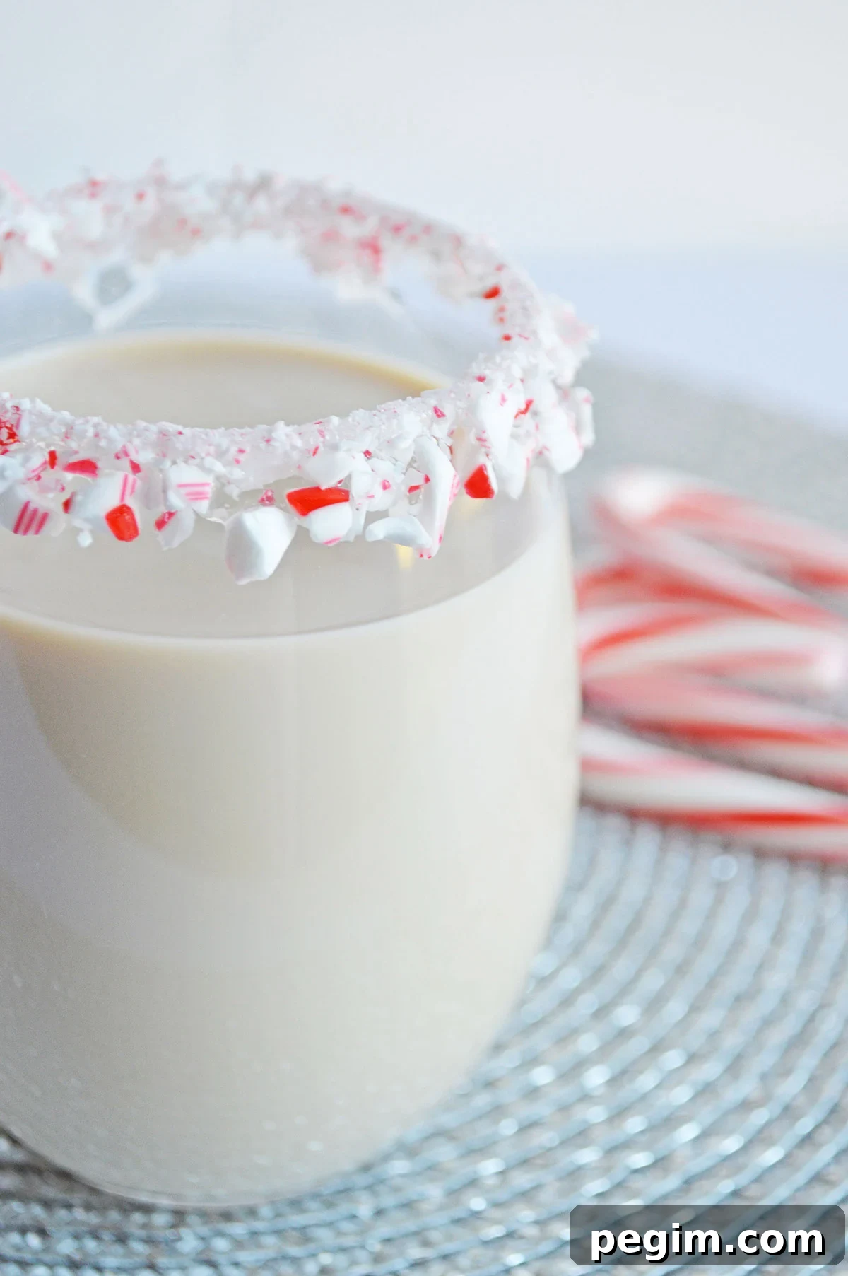 Peppermint White Russian Cocktail Recipe for the Holidays 2 peppermint white Russian in a glass with a candy cane rim
