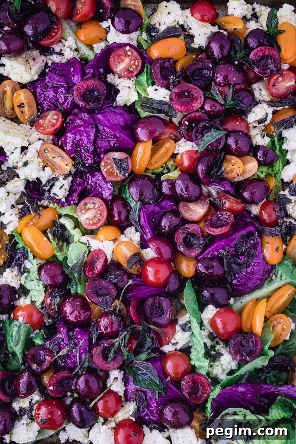 Cherry & Cherry Tomato Summer Salad with purple cabbage, greens and baked feta.