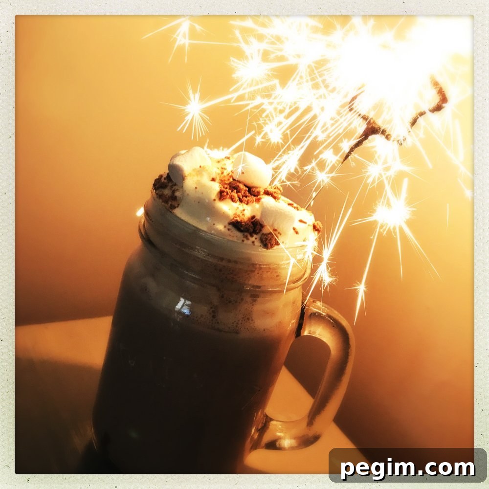 salted caramel hot chocolate with cream, marshmallows and a sparkler