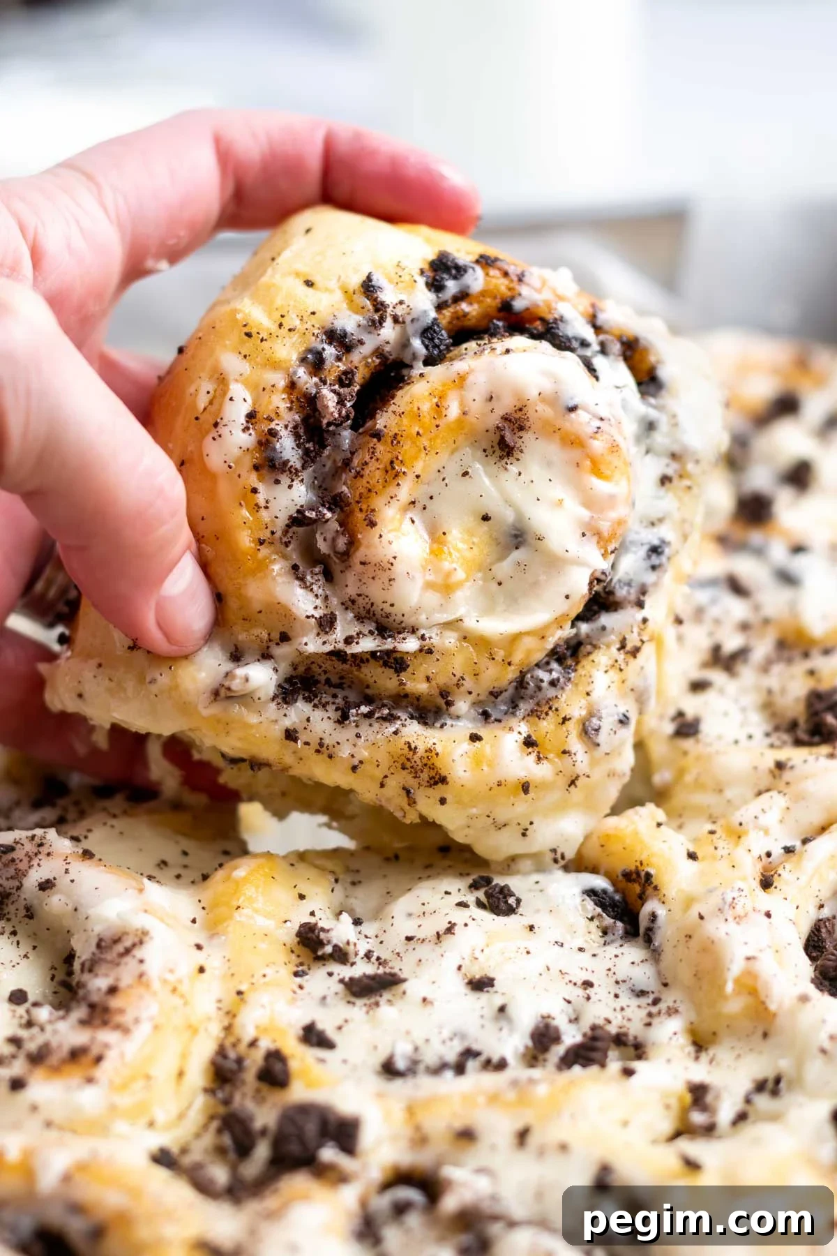 hand grabbing an oreo cinnamon roll