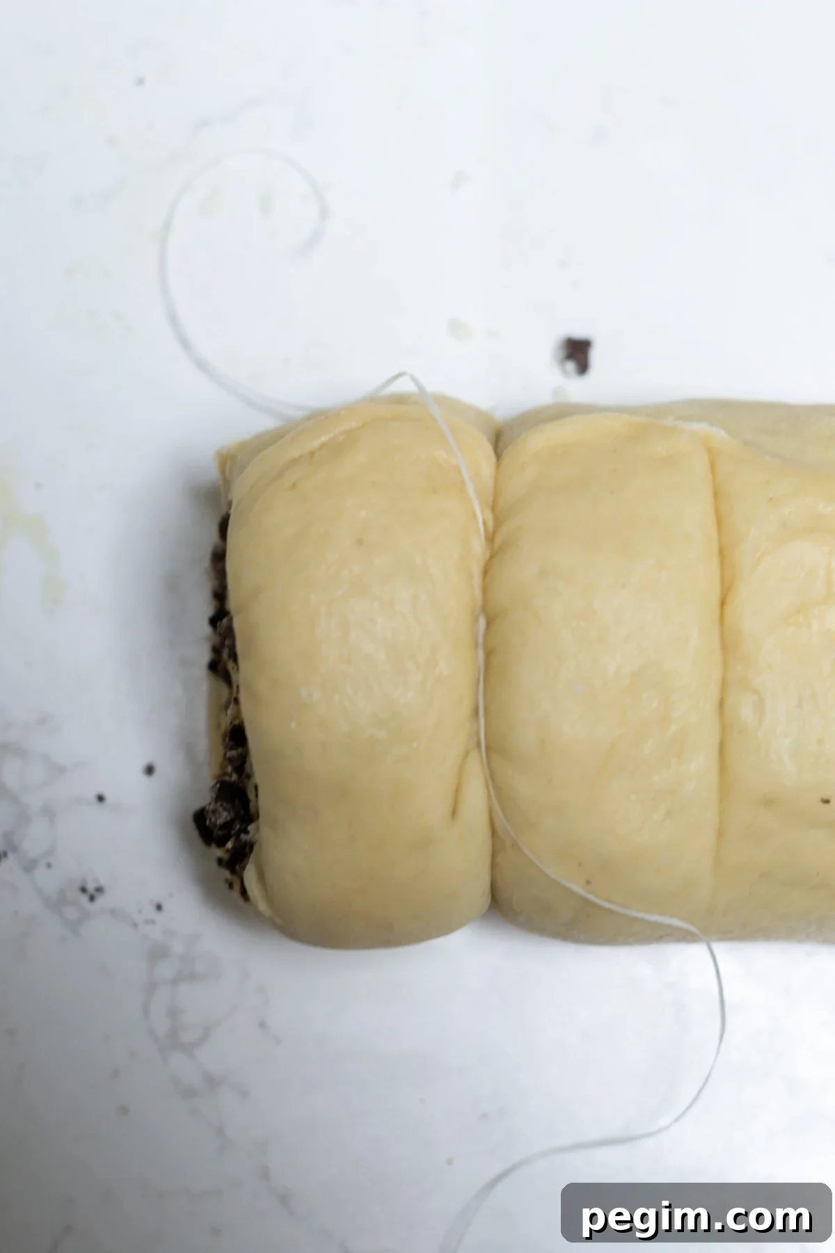 using dental floss to cut oreo cinnamon rolls