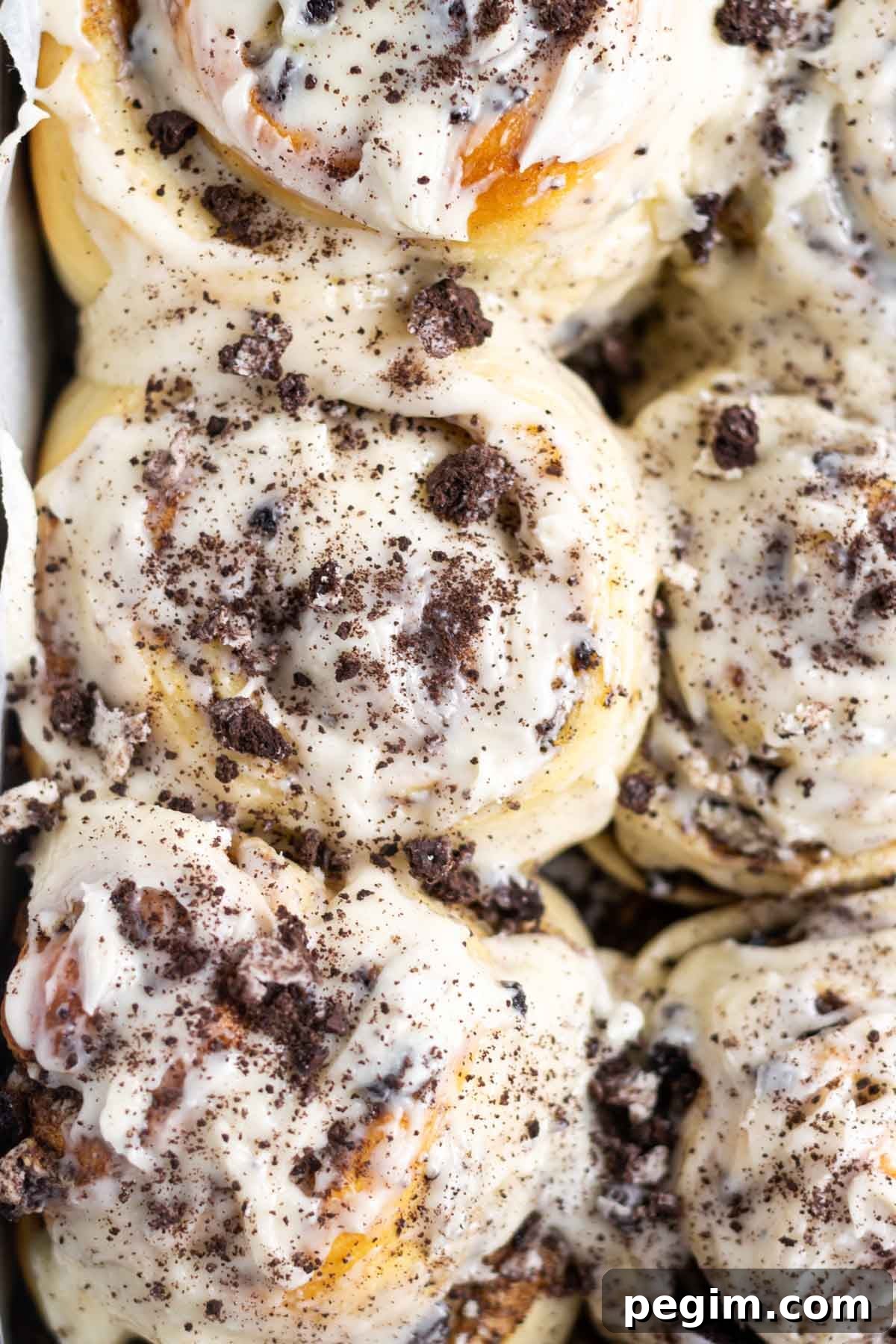 oreo cinnamon rolls with icing and crumbled Oreos