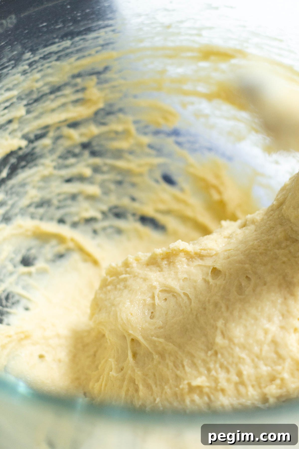 oreo cinnamon roll dough sticking to the edges of the mixing bowl.