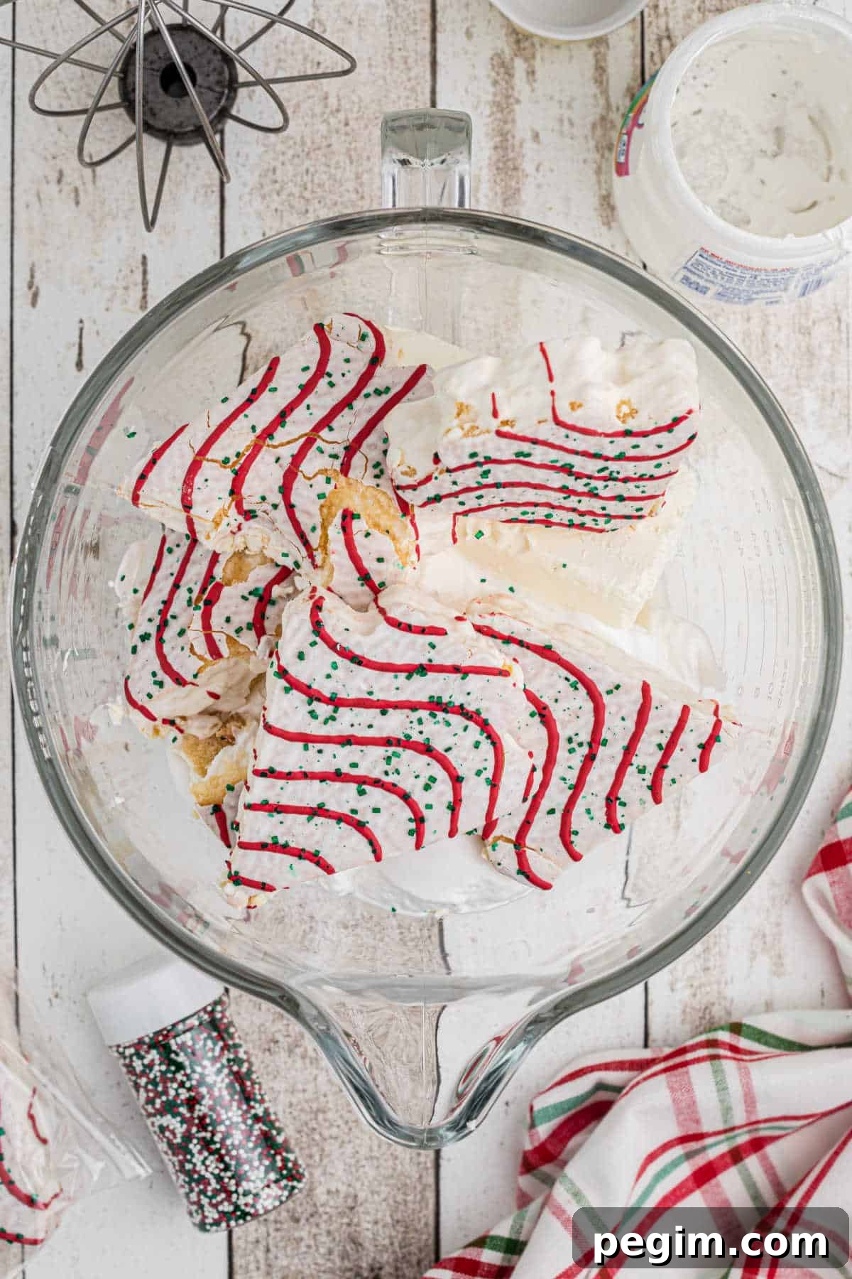 Ingredients thrown into a stand mixer bowl. Process image for making Christmas Tree Dip.