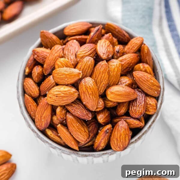 Olive oil roasted almonds in a small round bowl.