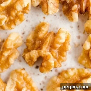 Walnut halves on a speckled background.