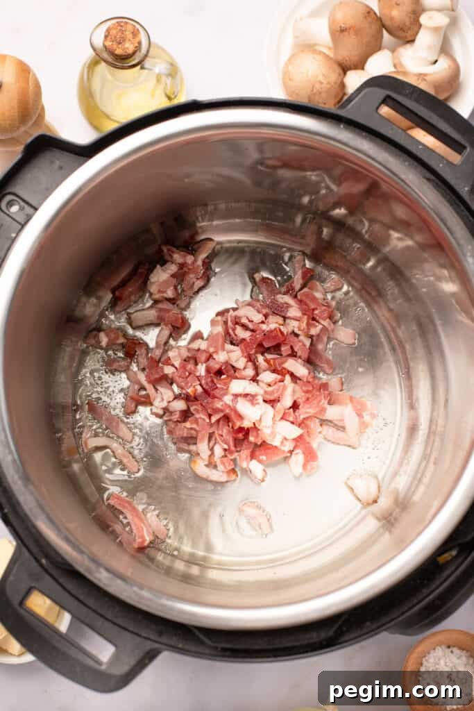 Diced bacon frying in an Instant Pot.