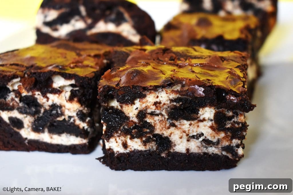Cookies and Cream Cheesecake Brownies Recipe 2 Cookies and cream cheesecake brownies on a plate.