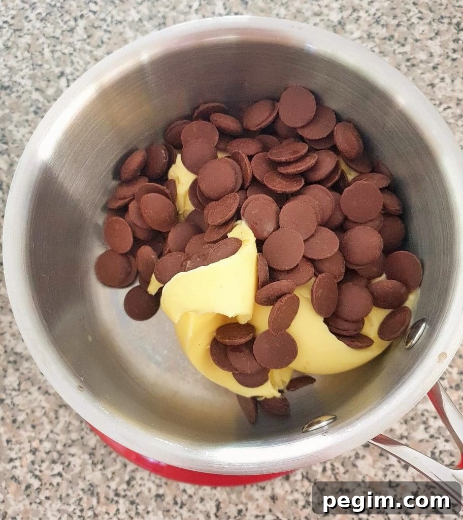 Cookies and Cream Cheesecake Brownies Recipe 7 Chocolate and butter in a saucepan.