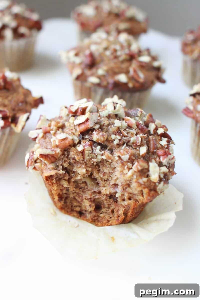 Whole Wheat Banana Nut Muffins Recipe 5 banana nut muffins on a white marble cutting board