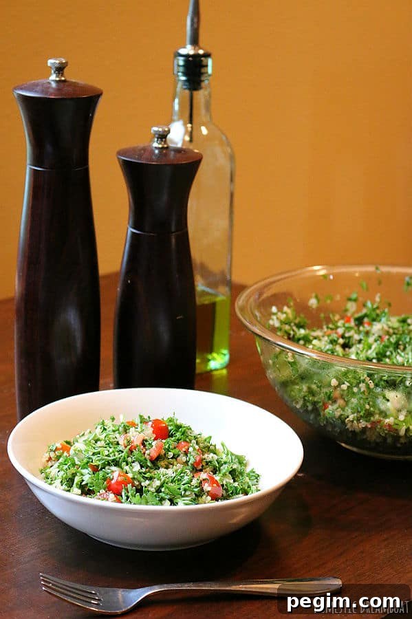 Lemon Quinoa Tabbouleh with Parsley & Mint 3 Quinoa Tabbouleh Salad in a white bowl.